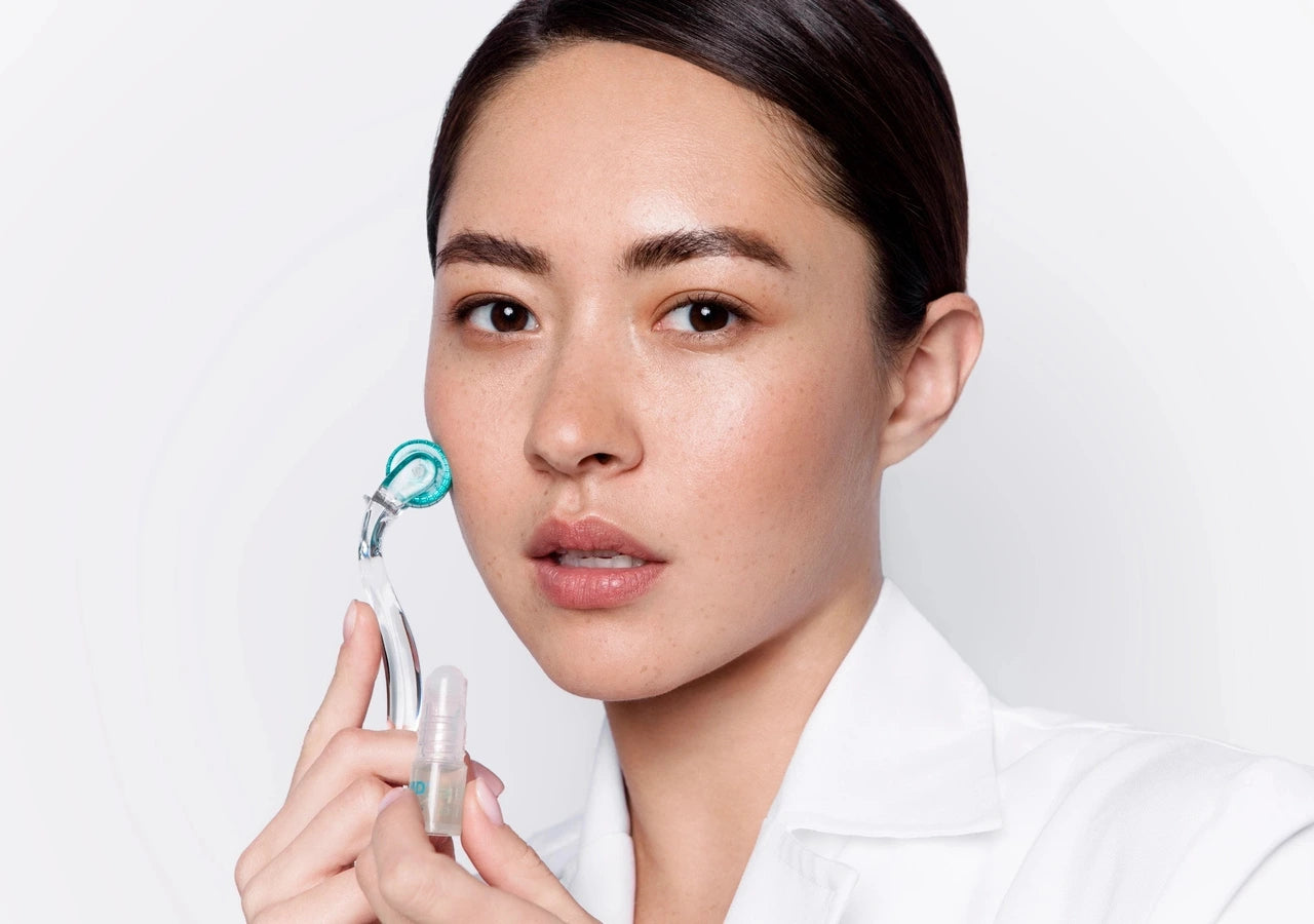 Woman holding AnteAGE Microneedling System and serum, designed for at-home collagen induction therapy with Bone Marrow Stem Cytokines and hyaluronic acid.