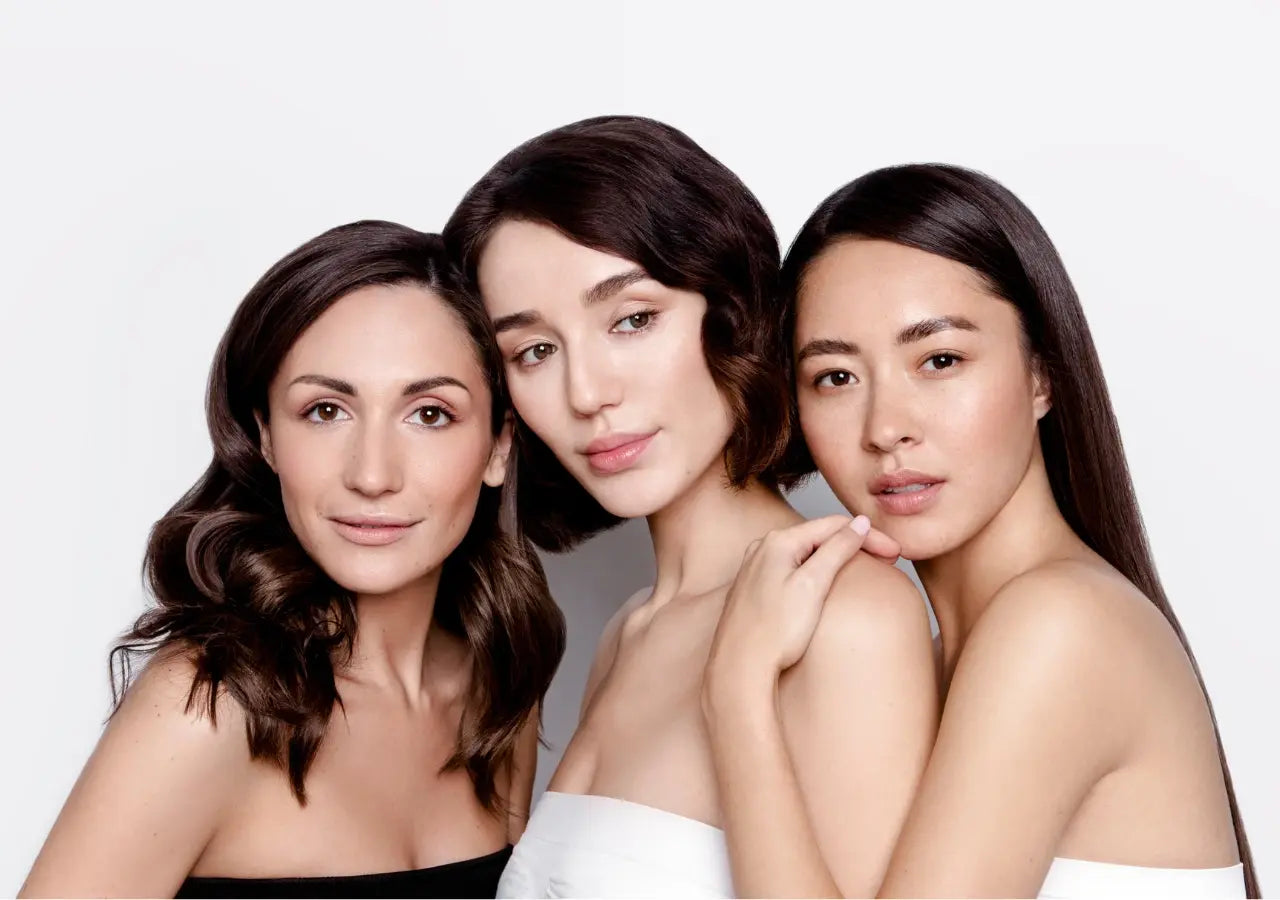 Three women with flawless, radiant skin showcasing the results of AnteAGE Regenzyme, a gentle non-acid exfoliant with botanical enzymes and antioxidants.