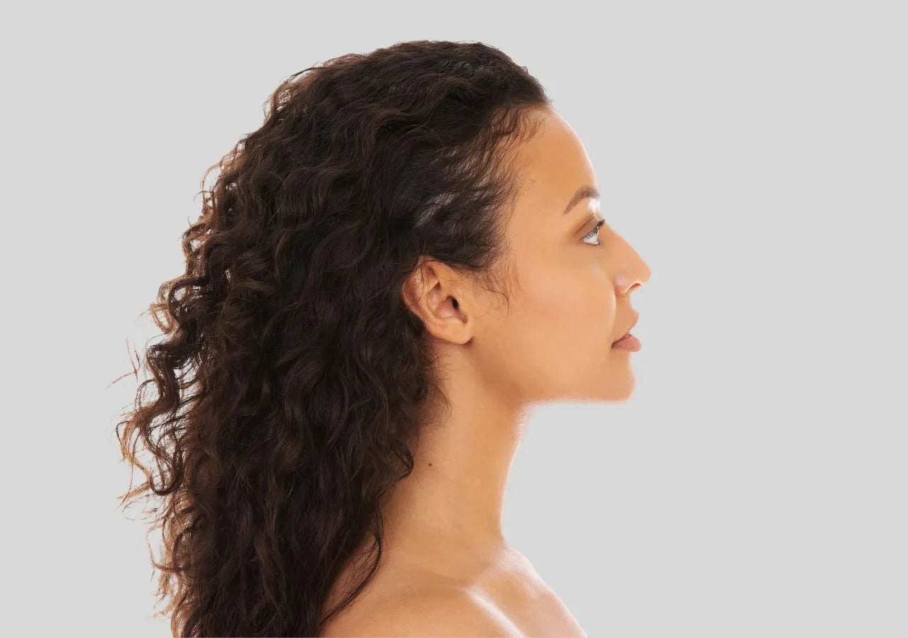 Close-up of a woman's radiant face with smooth, glowing skin, showcasing a healthy and refreshed complexion.