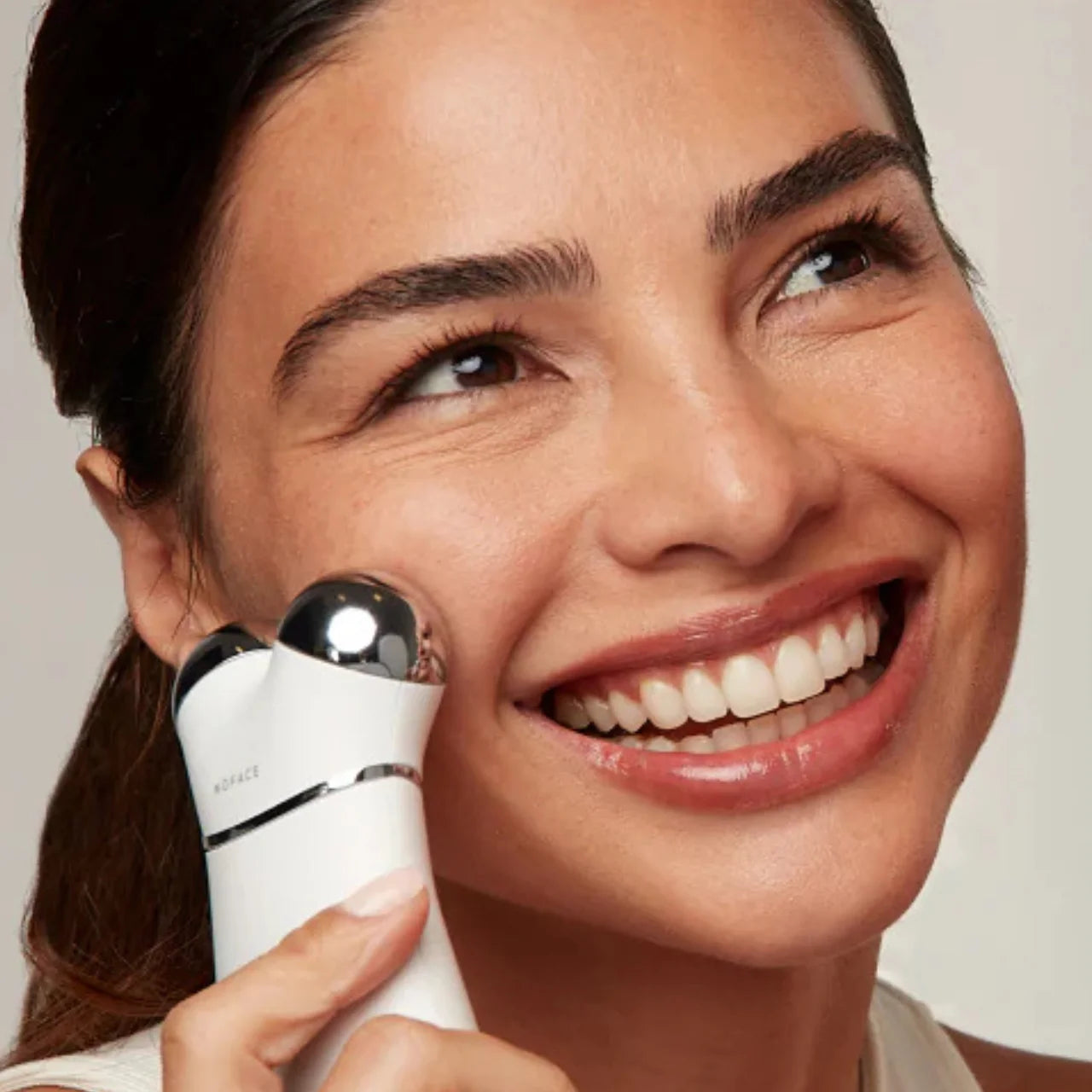 NuFACE TRINITY+ LED Red Light Wrinkle Reducer Attachment promoting radiant skin renewal by targeting dullness and rough texture with red light therapy.