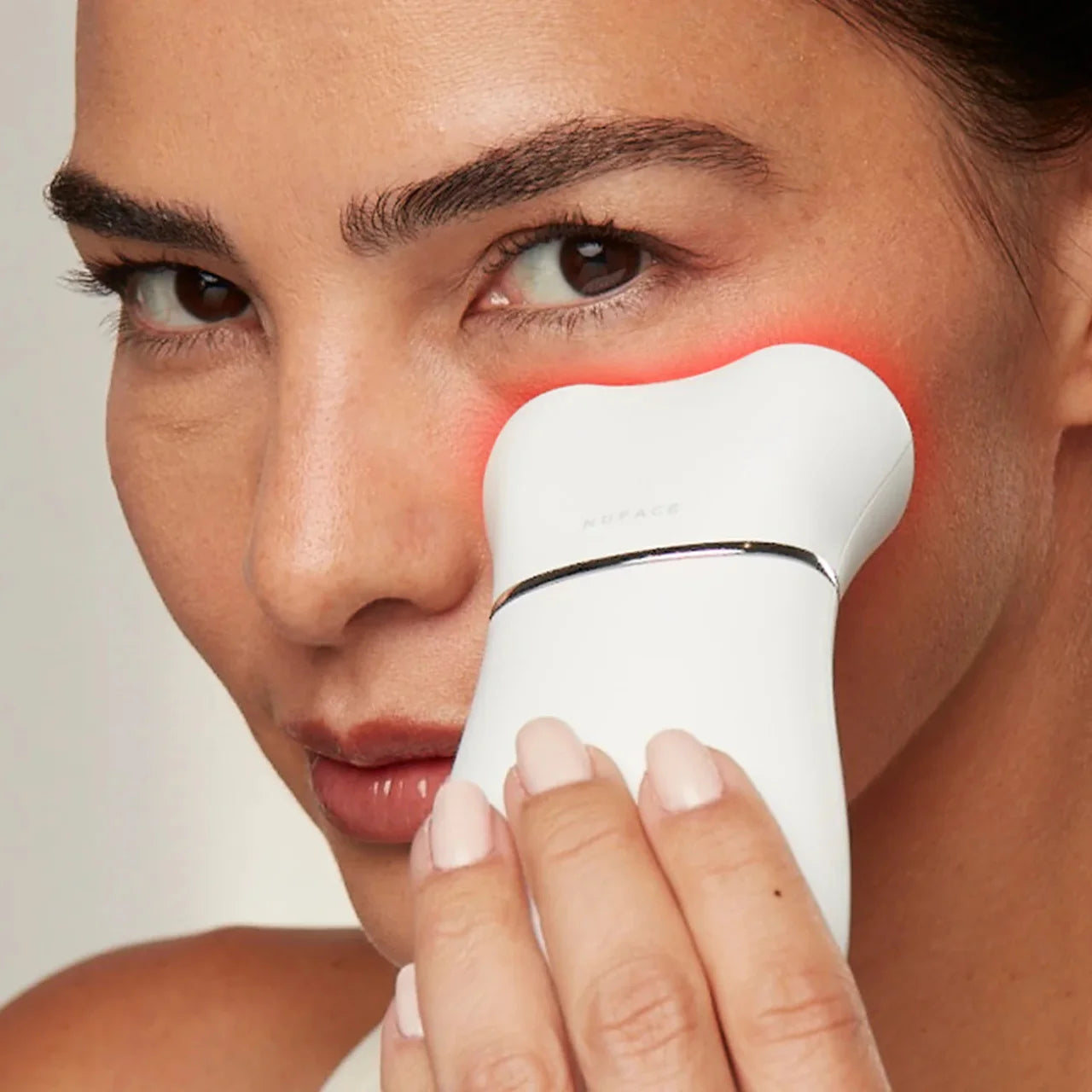 NuFACE TRINITY+ LED Red Light Wrinkle Reducer Attachment visibly smoothing fine lines and wrinkles with red, amber, and infrared light for firmer skin.