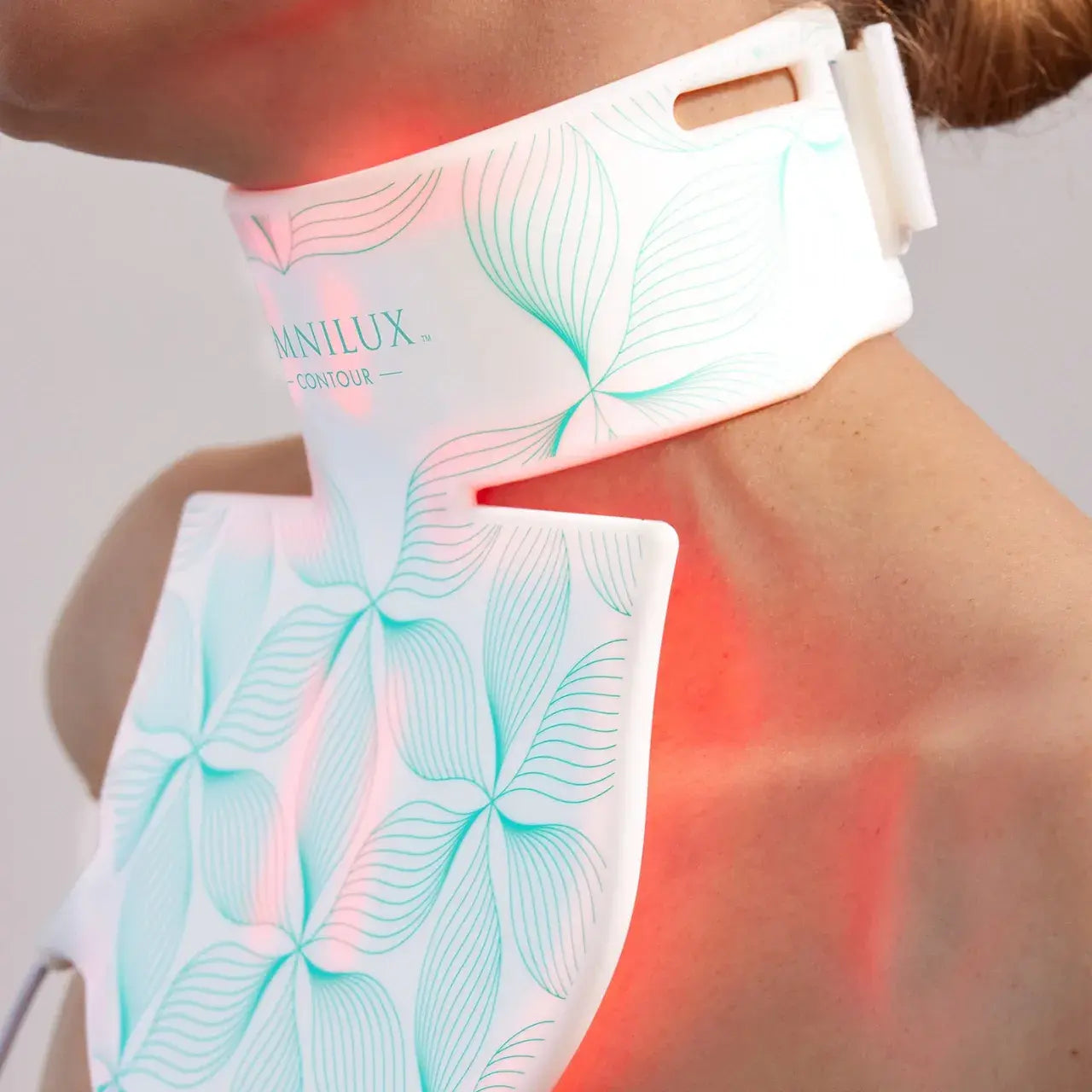 Omnilux Contour Neck & Décolleté is a flexible, portable red light therapy device, safe for sensitive skin, and easy to use at home.