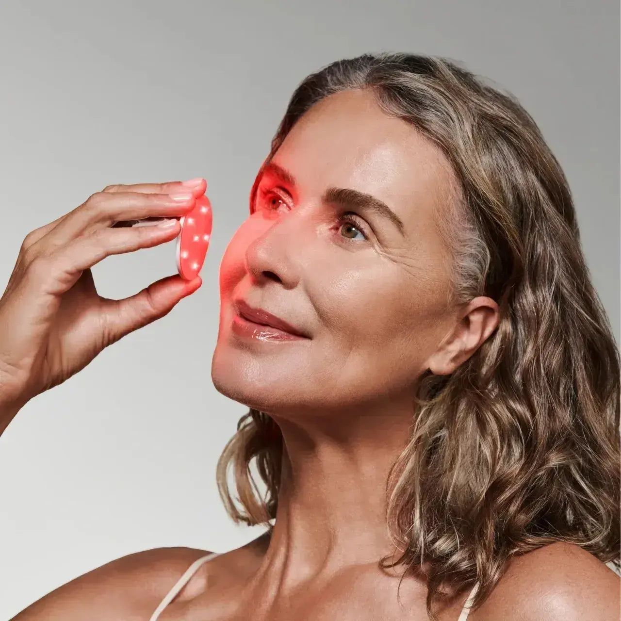 Omnilux Skin Corrector, a red light therapy device that reduces wrinkles, evens skin tone, and rejuvenates skin for a youthful glow.