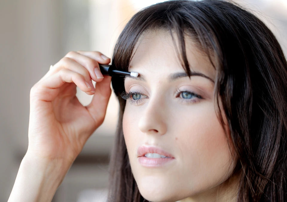 Woman applying a gentle, fast-absorbing brow serum with a lightweight, non-irritating formula that is safe for all skin types and absorbs quickly.